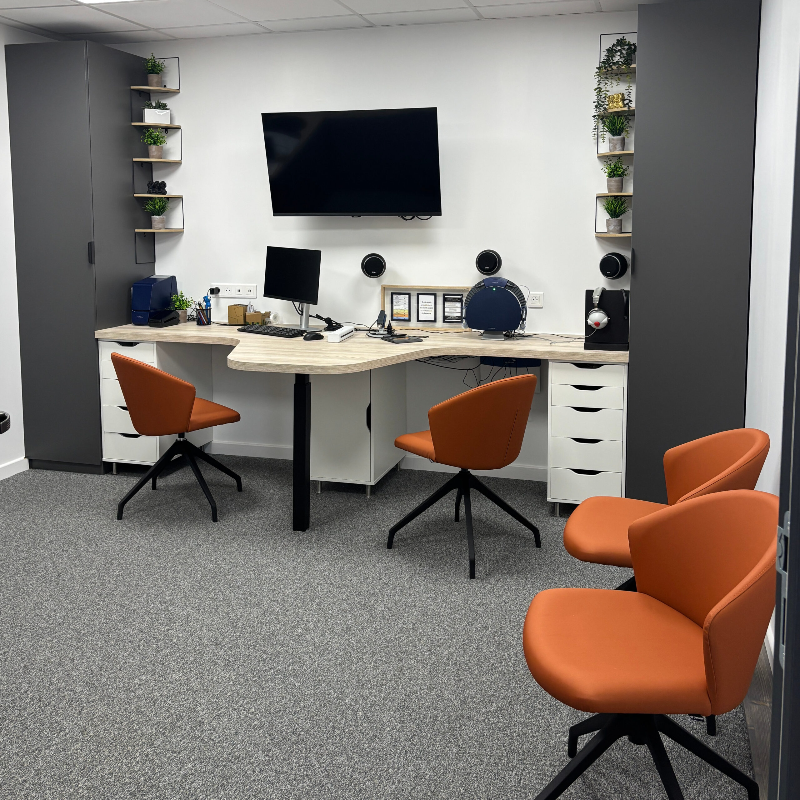 Salle d'examen en audologie comportant tout le matériel nécessaire à un examen et des chaises pour les accompagnateurs